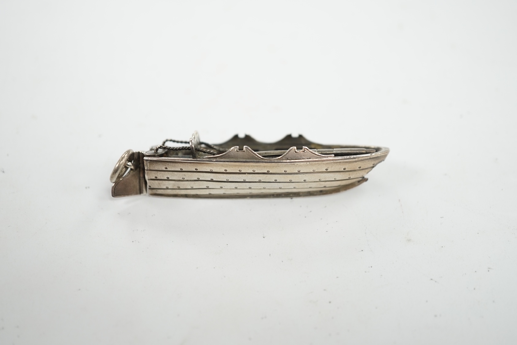 A Sampson Mordan and Co white metal novelty propelling pencil, modelled as a rowing boat, 60mm. Condition - poor. (oar missing)